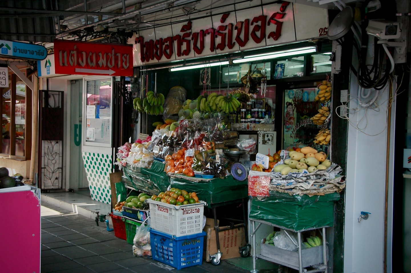 Baskets of tropical fruit displayed at an outdoor market stall.